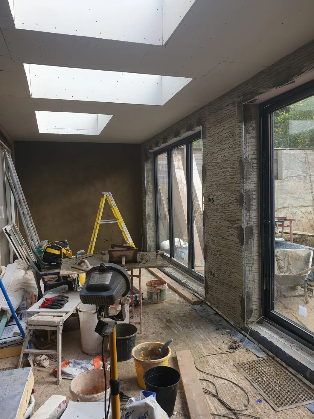 Internal sand and cement render in a North London extension
