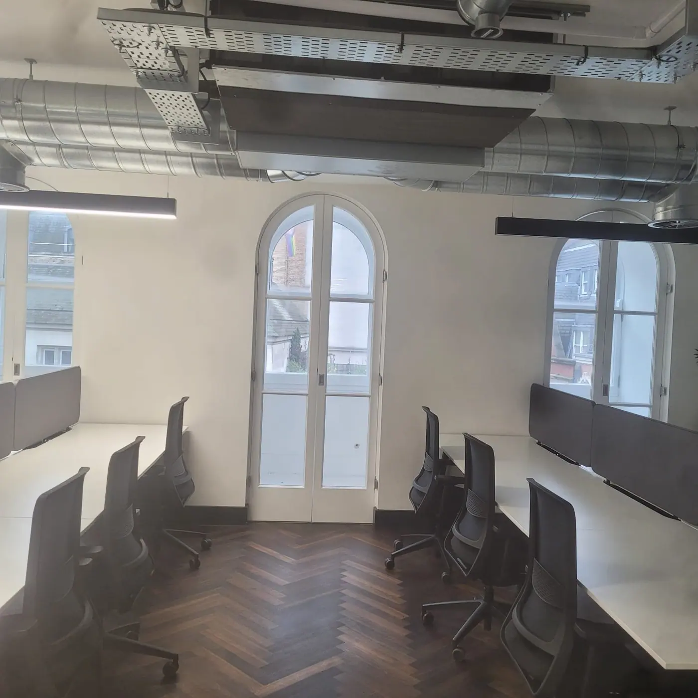 A finished office with arched windows and freshly plastered white walls, Liverpool Street