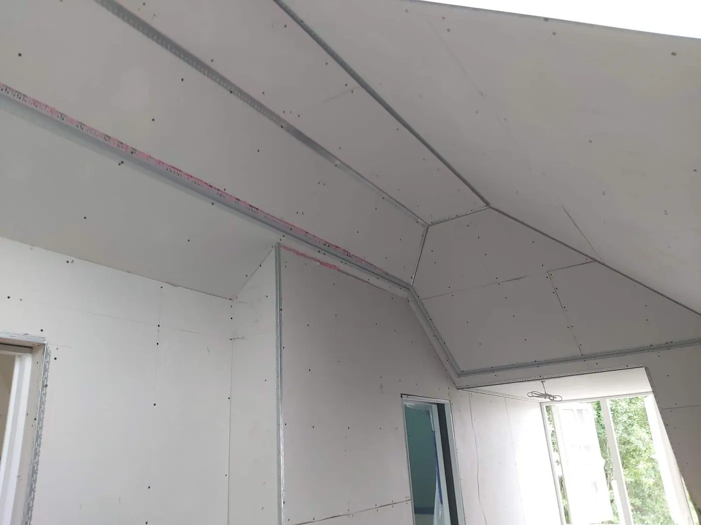 Plasterboard fixed to sloping ceilings on a Highgate top floor