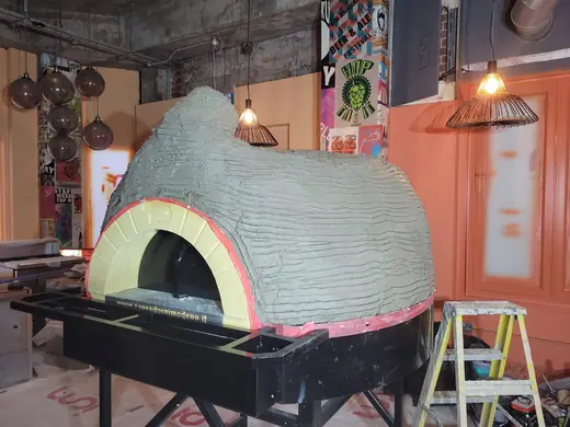 An oven dome in its first render coat
