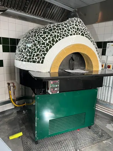 A tiled oven with its rendered arch