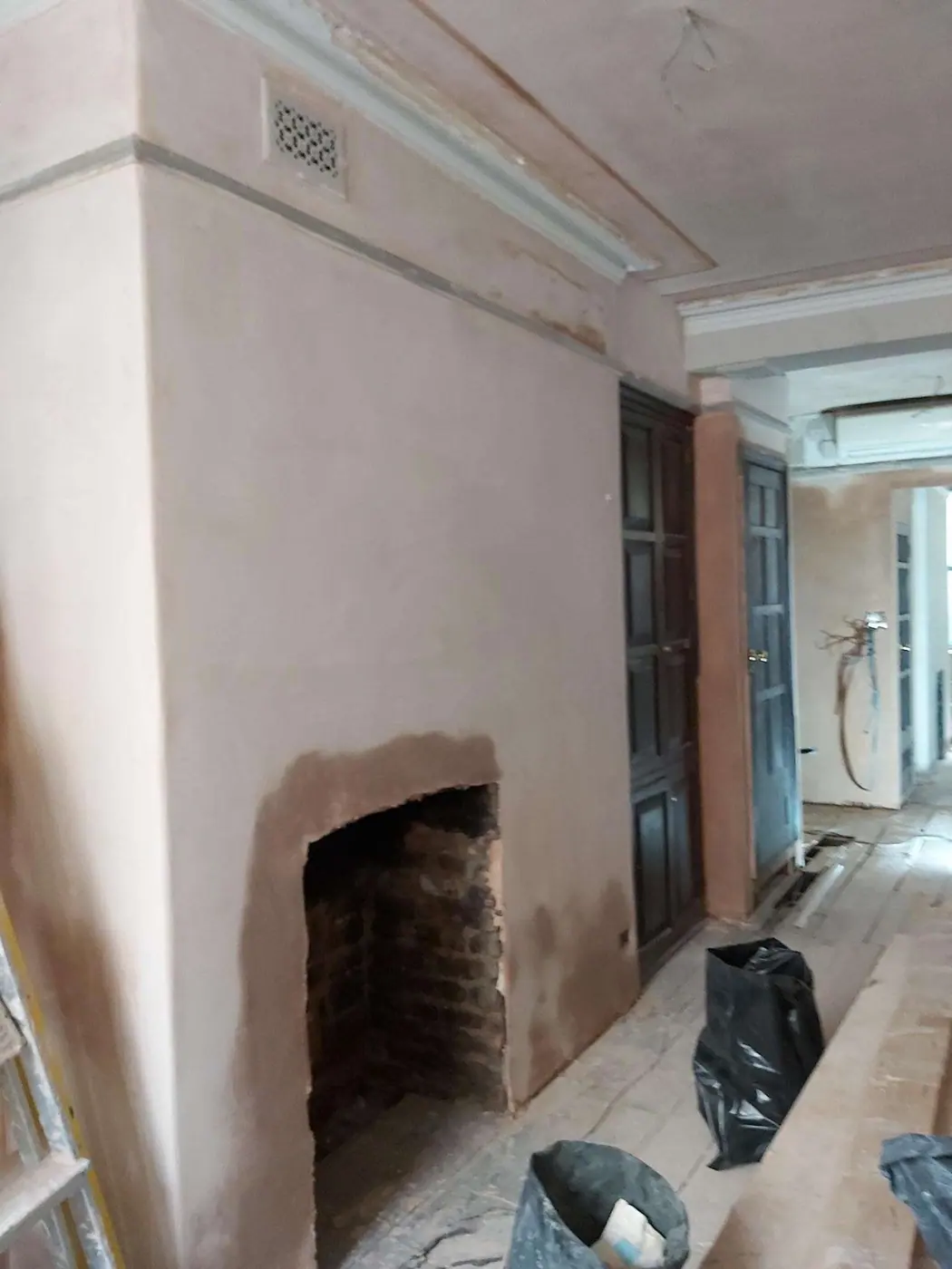The fireplace wall freshly replastered